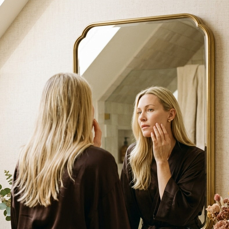 Woman looking at her skin in a mirror